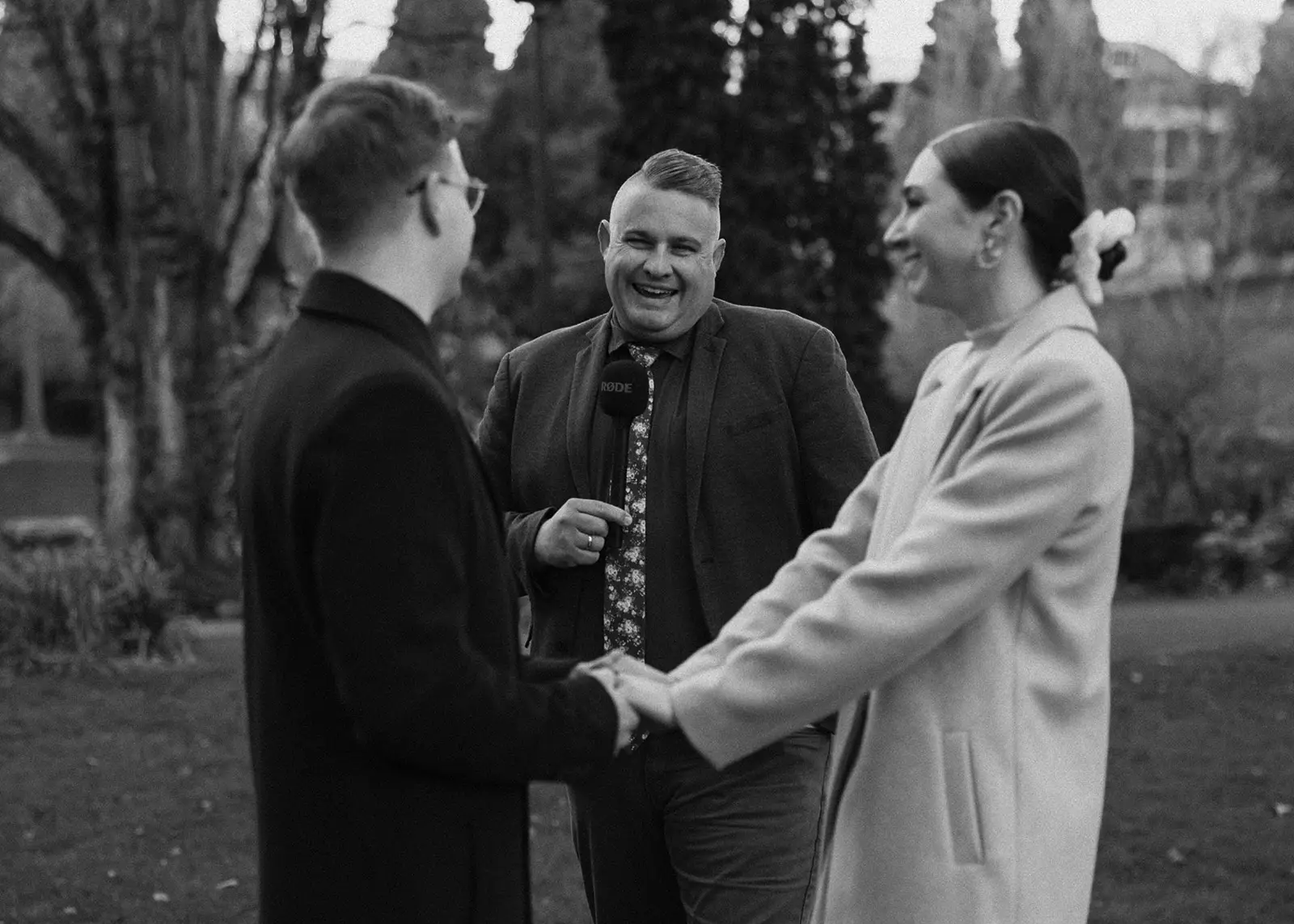 A newlywed couple crosses a street in Hobart, Tasmania, after their intimate elopement, walking hand in hand past historic buildings and urban charm, capturing the essence of a small, meaningful wedding.